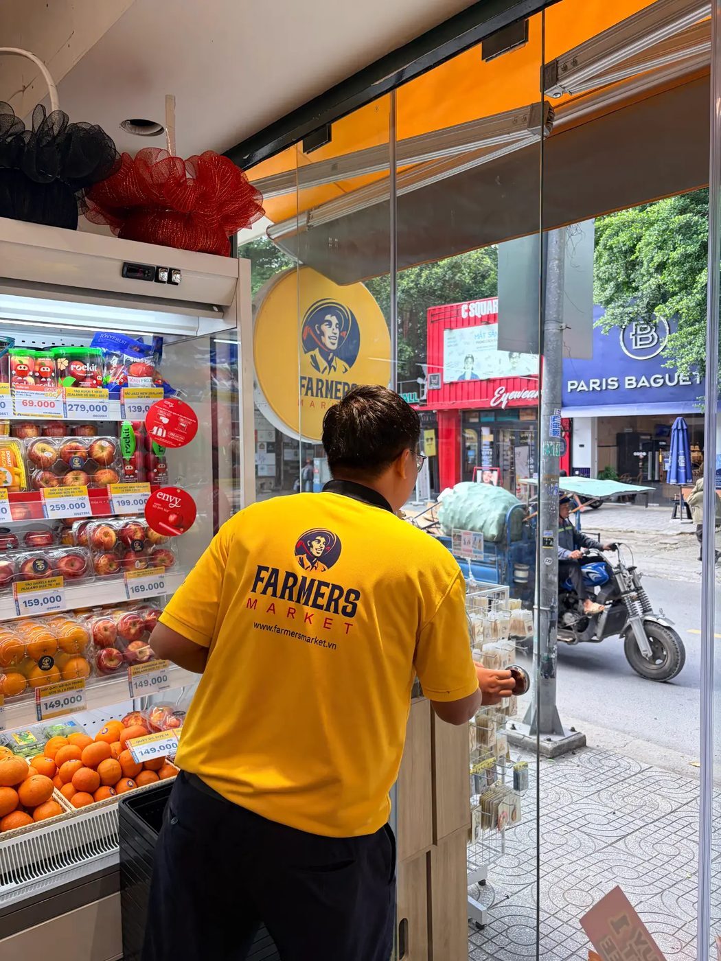 A vendor opening up the neighborhood fruit market in the morning